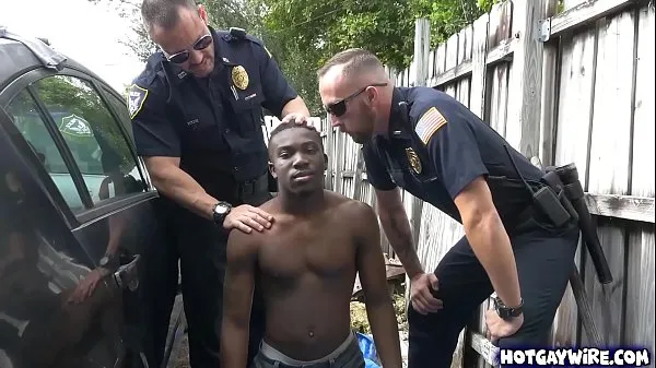 Two police officers take advantages of this black guy